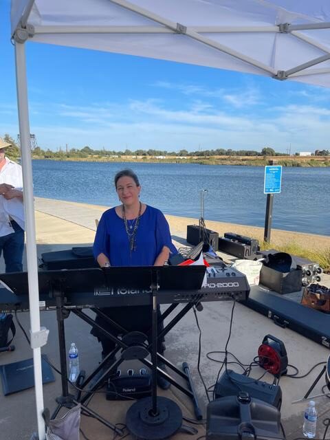 A band playing on the lake docks for the community at Michael Vega Park in River Islands