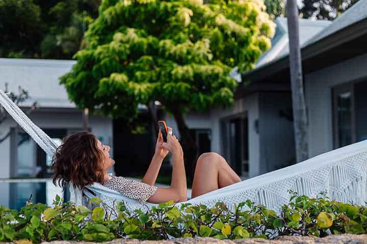 woman laying in hammock