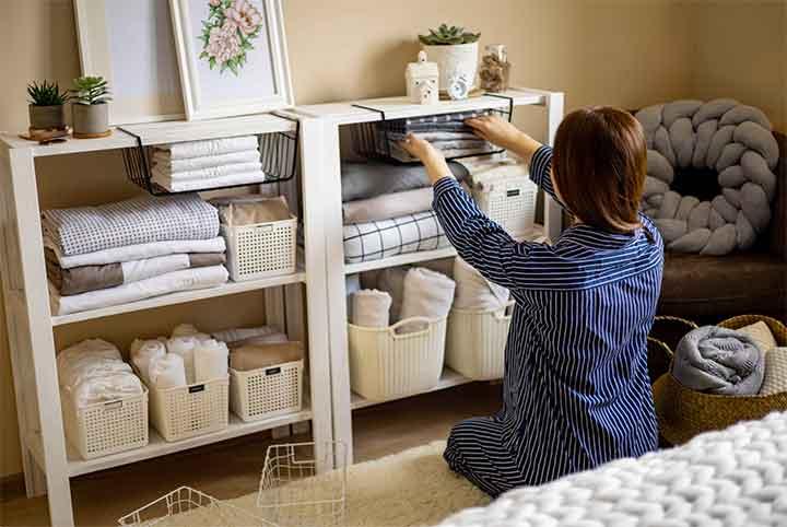 woman organizing shelf