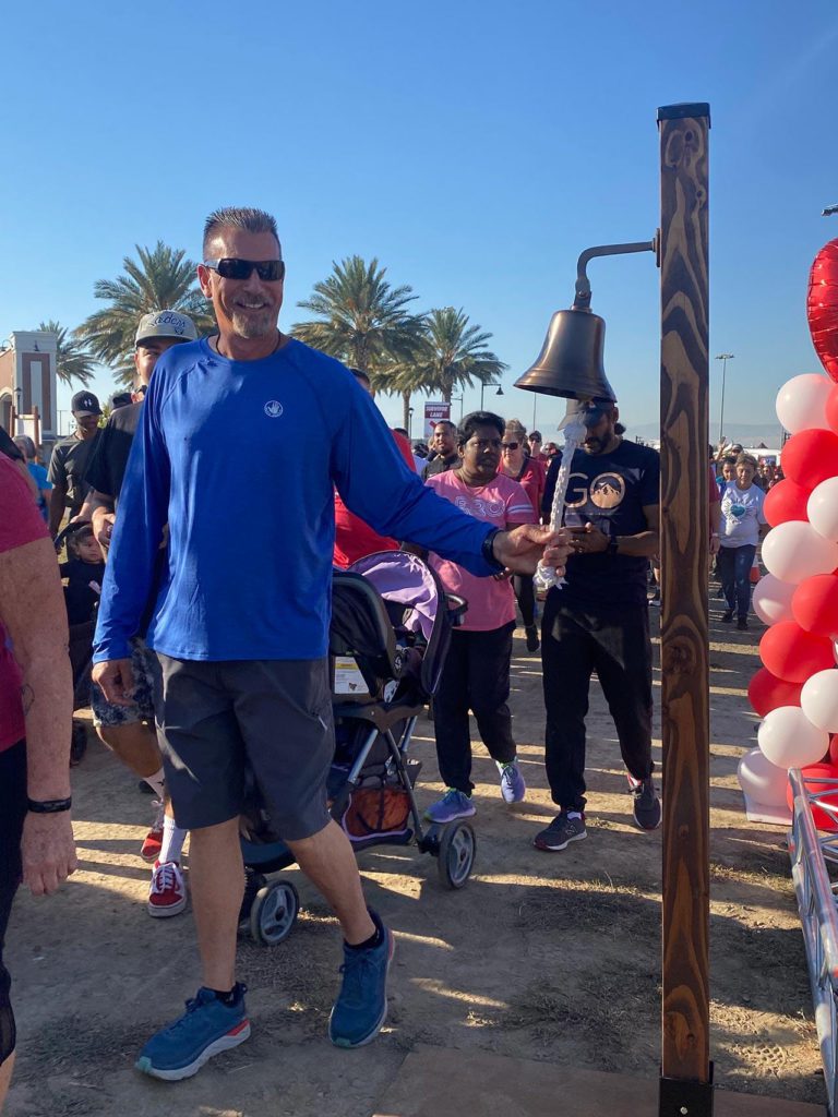 participant of the AHA Heart Walk ringing bell